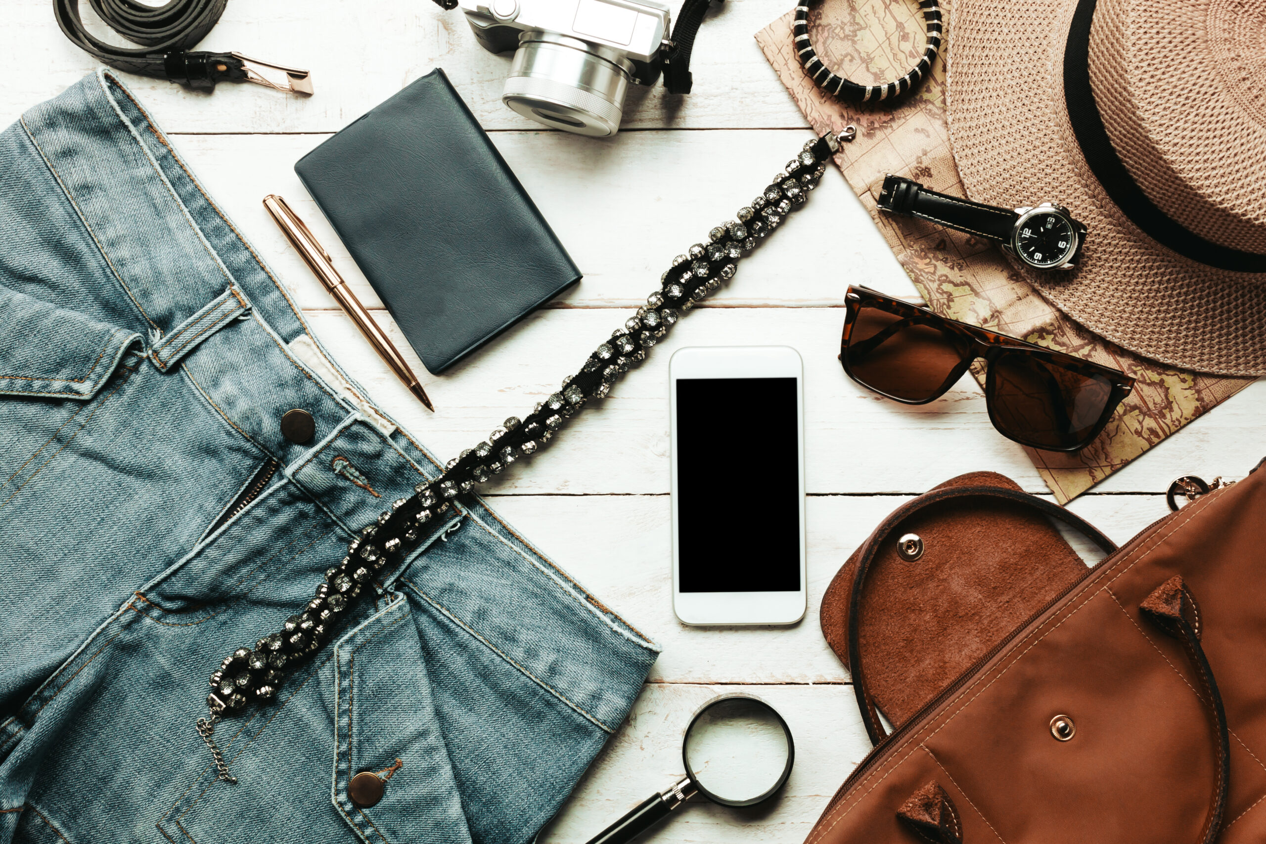 top view accessoires to travel with women clothing concept.white